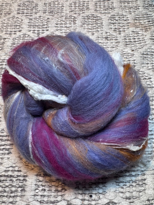 Multicolored roving on a textured fabric background