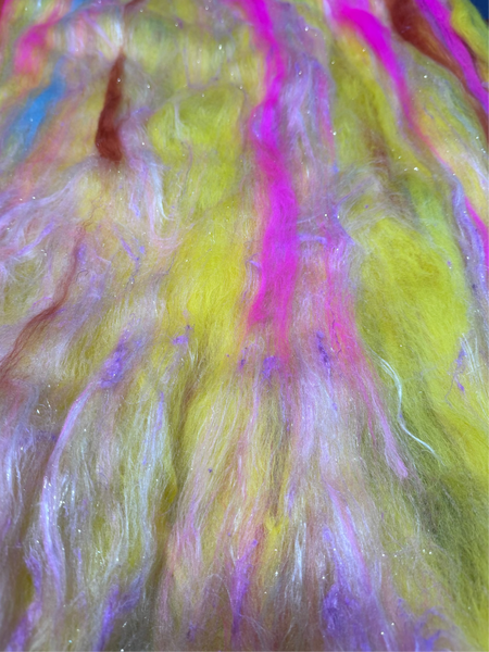 Close-up of multicolored fibers with pink, yellow, and purple hues.